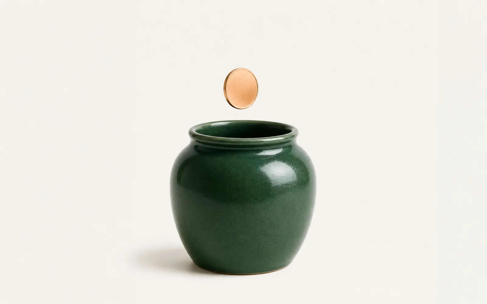 A plain coin dropping into a green savings jar