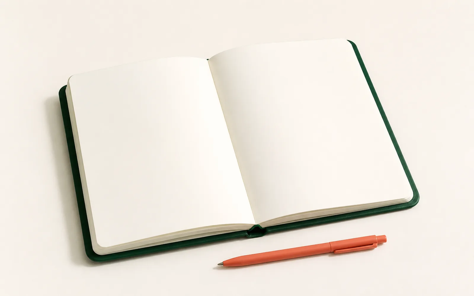 An open planning notebook with a coral pen